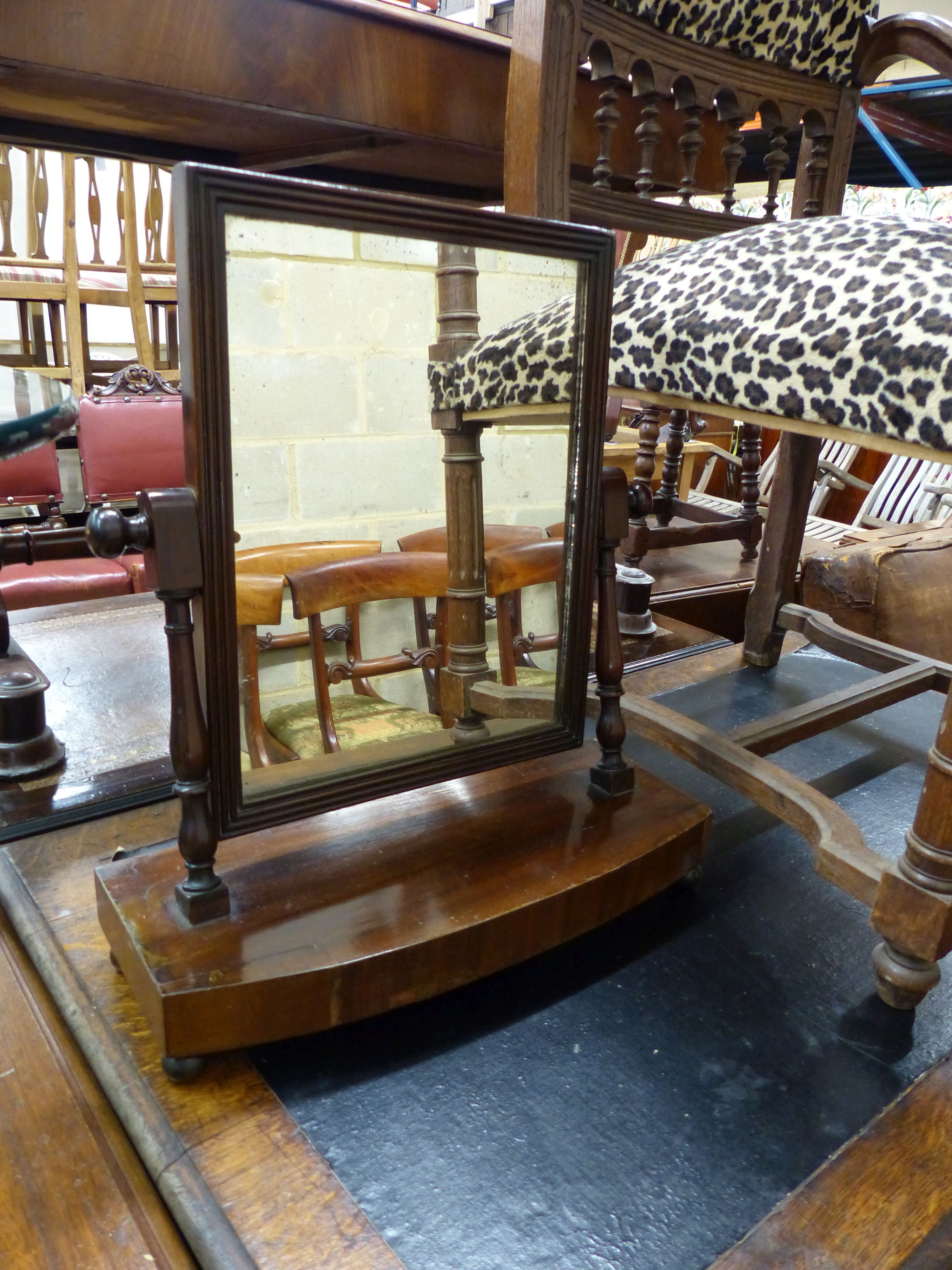 A late 19th century leopard print upholstered elbow chair and a mahogany toilet mirror